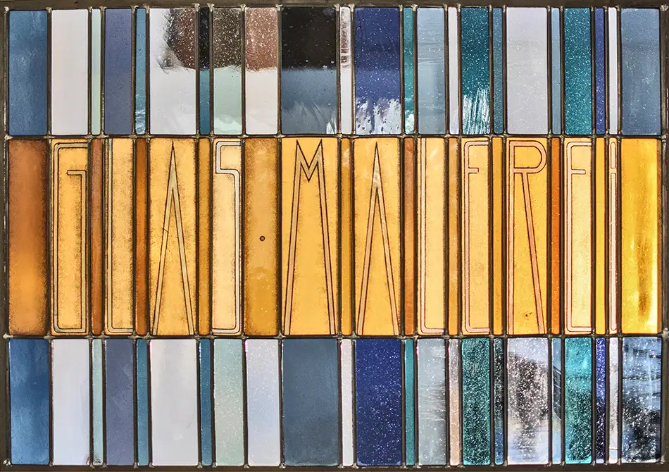 Stained glass window at Tiroler Glasmalerei with Art Nouveau lettering