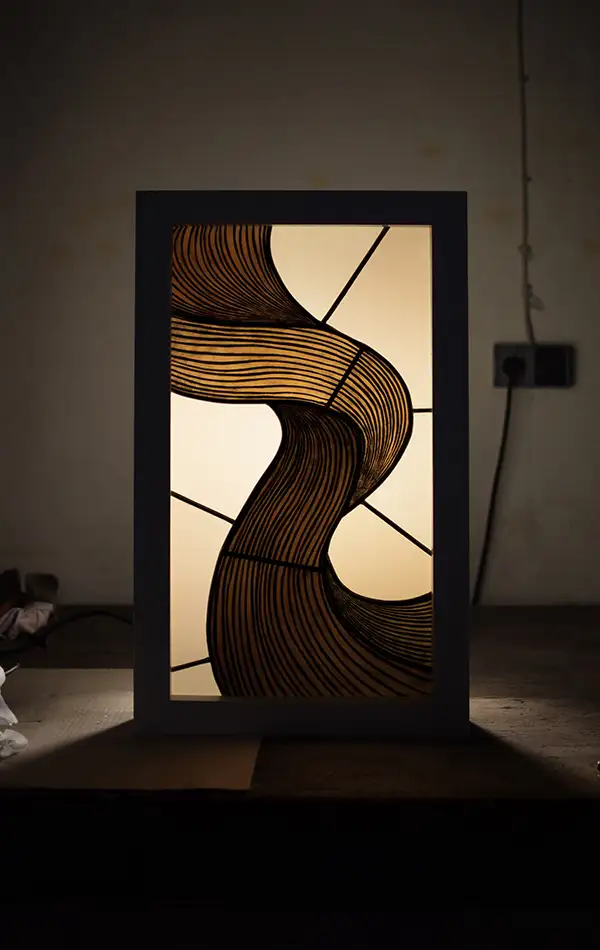 Detail of a stained glass window with a painted depiction of a serpentine ribbon in shades of brown and beige