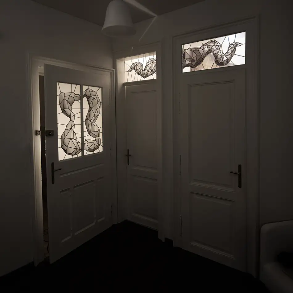 Monochrome stained glass with geometric pattern in old building entrance door and fanlights