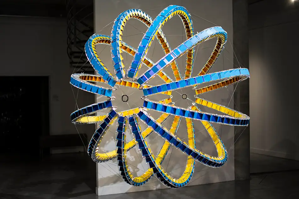 Exhibition view of spherical art installation LudoModuL which plays with colour changes using different coloured wooden cubes