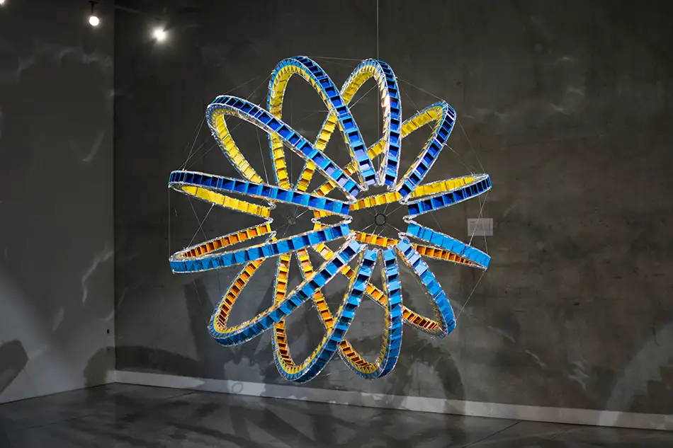 Exhibition view of spherical art installation LudoModuL which plays with colour changes using different coloured wooden cubes