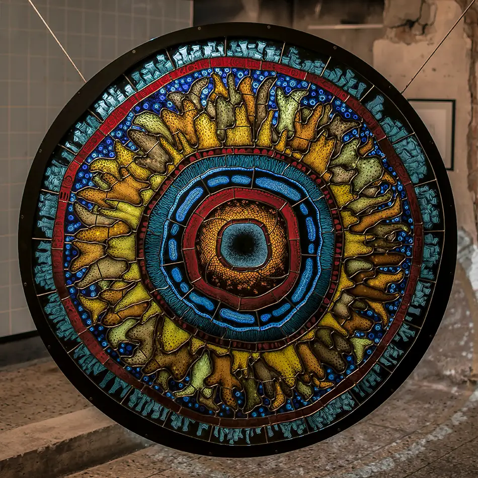 Detailed painted stained glass reminiscent of a gigantic fluorescent cell