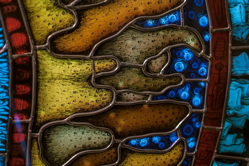 Detail of a detailed painted lead glazing reminiscent of a gigantic fluorescent cell