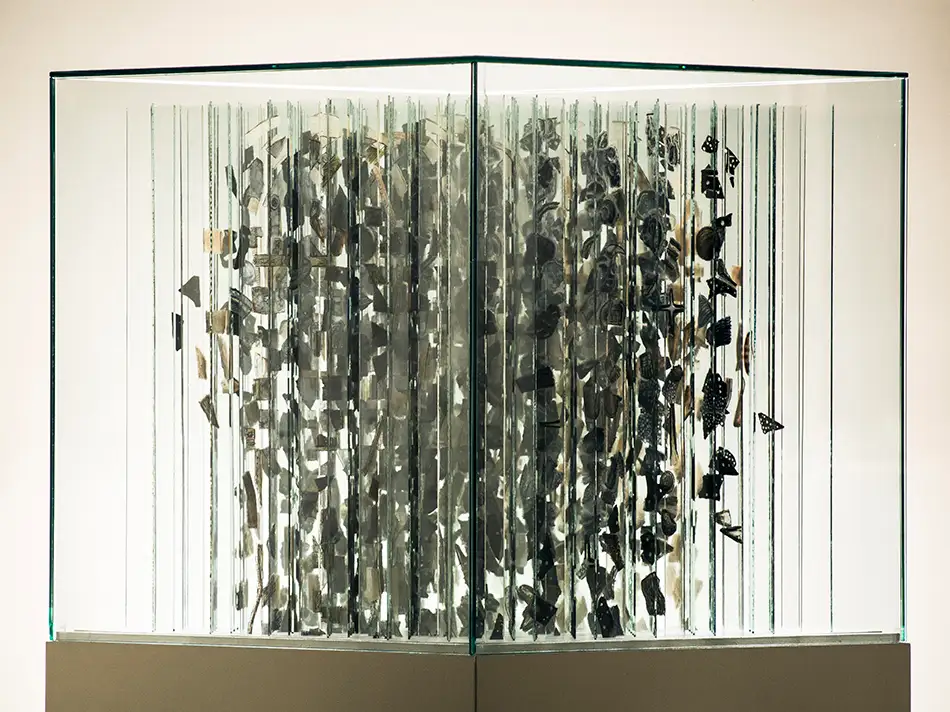 Anamorphic artwork - glass cube with four different images composed of image fragments - cloud of image fragments