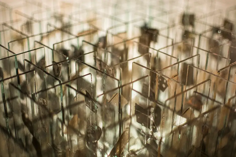 Anamorphic artwork - glass cube with four different images composed of image fragments - glass strips