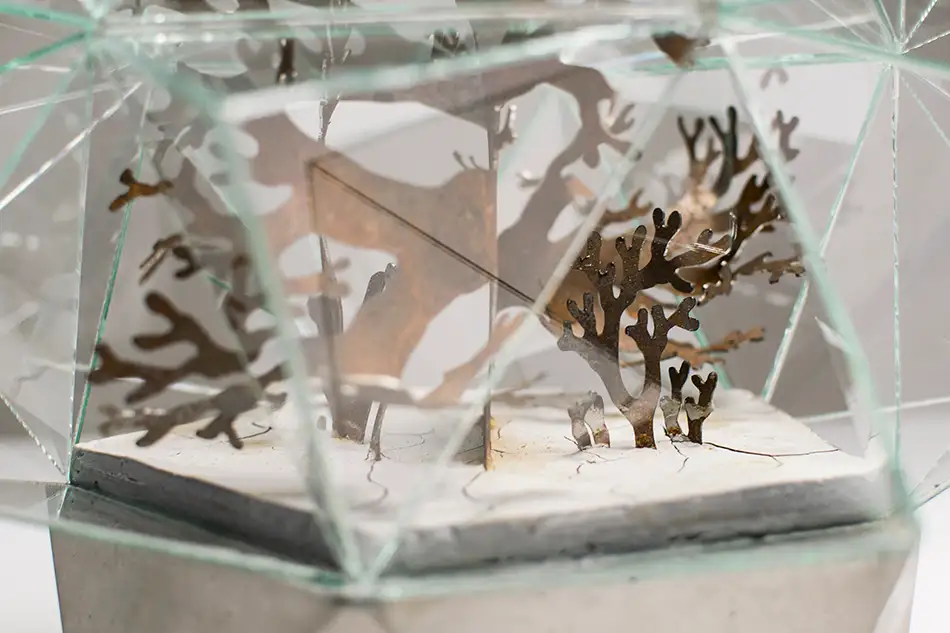 Artwork reminiscent of a greenhouse, consisting of a geometric glass enclosure, a concrete plinth and a plant-like steel structure - detail