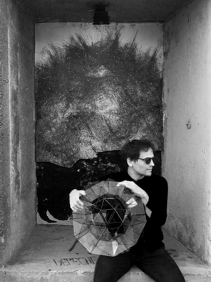 spherical glass sculpture that is geometrically based on the geodesic dome - with Thomas Medicus while he is holding the sphere